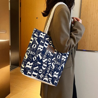 通学女子学生用新作キャンバスバッグ、通勤用ショルダーバッグ、大容量、おしゃれでシンプルなプリント文字ハンドバッグ、女性用