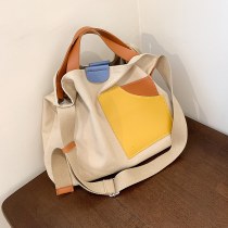 2024 秋斜めキャンバスバッグ大容量の女性の通勤トートバッグニッチデザインポータブル ショルダー バッグ