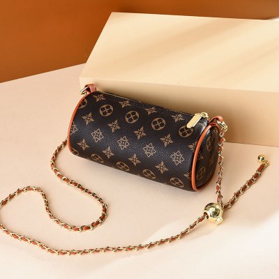 女性用バッグ 2024 新しい円筒形バッグファッショナブルで多用途な小さなゴールドボールチェーンショルダーバッグインターネットセレブデザインクロスボディバッグ