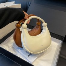 春の新作女性用ワンショルダー脇バッグ、トレンドの韓国版ニッチムーンバッグ、トレンドのハーフムーンサドルバッグ