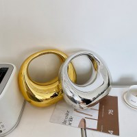 ヨーロッパとアメリカの高級ゴールドレディースバッグ、アクリル光沢のある脇の下バッグ、ファッショントレンディなクロスボディバッグ